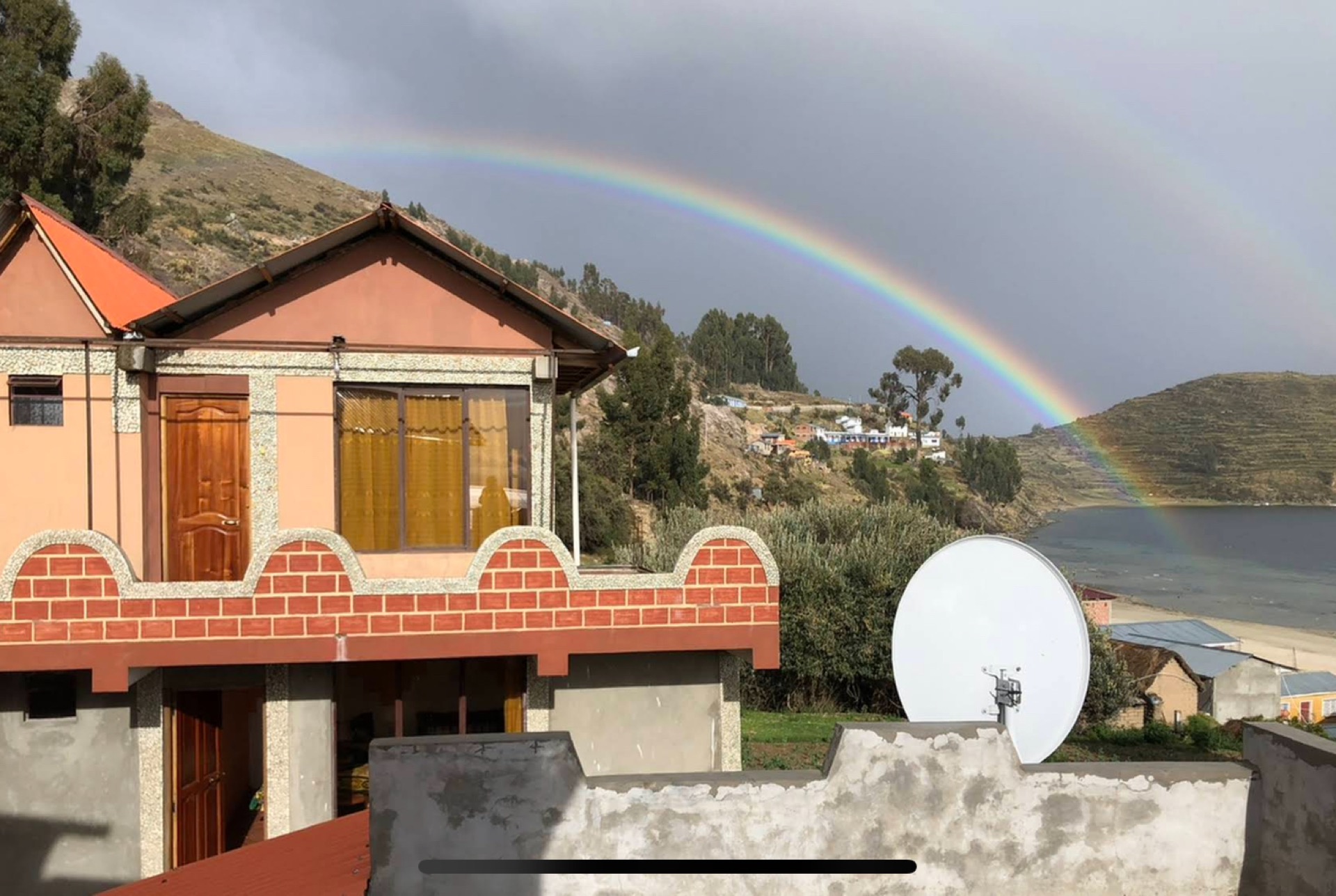 Hostal Margarita with rainbow over Lake Titicaca